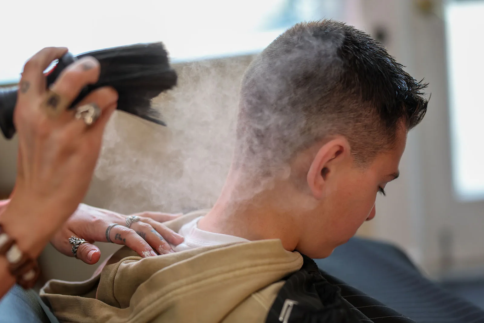 The finishing touch on a straight-razor shave at Black Hat Barber