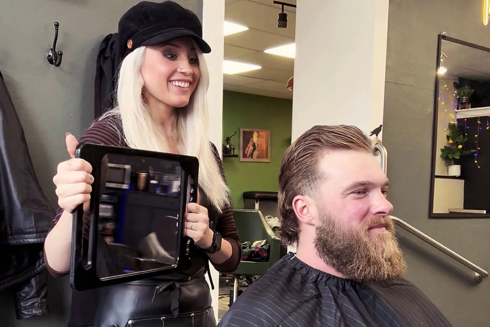 Master barber Ren Faith consulting with a client about beard shape at Black Hat Barber, downtown Willoughby Ohio