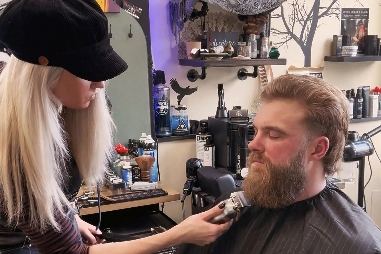 Shaping a beard with scissors and clippers at Black Hat Barber in downtown Willoughby