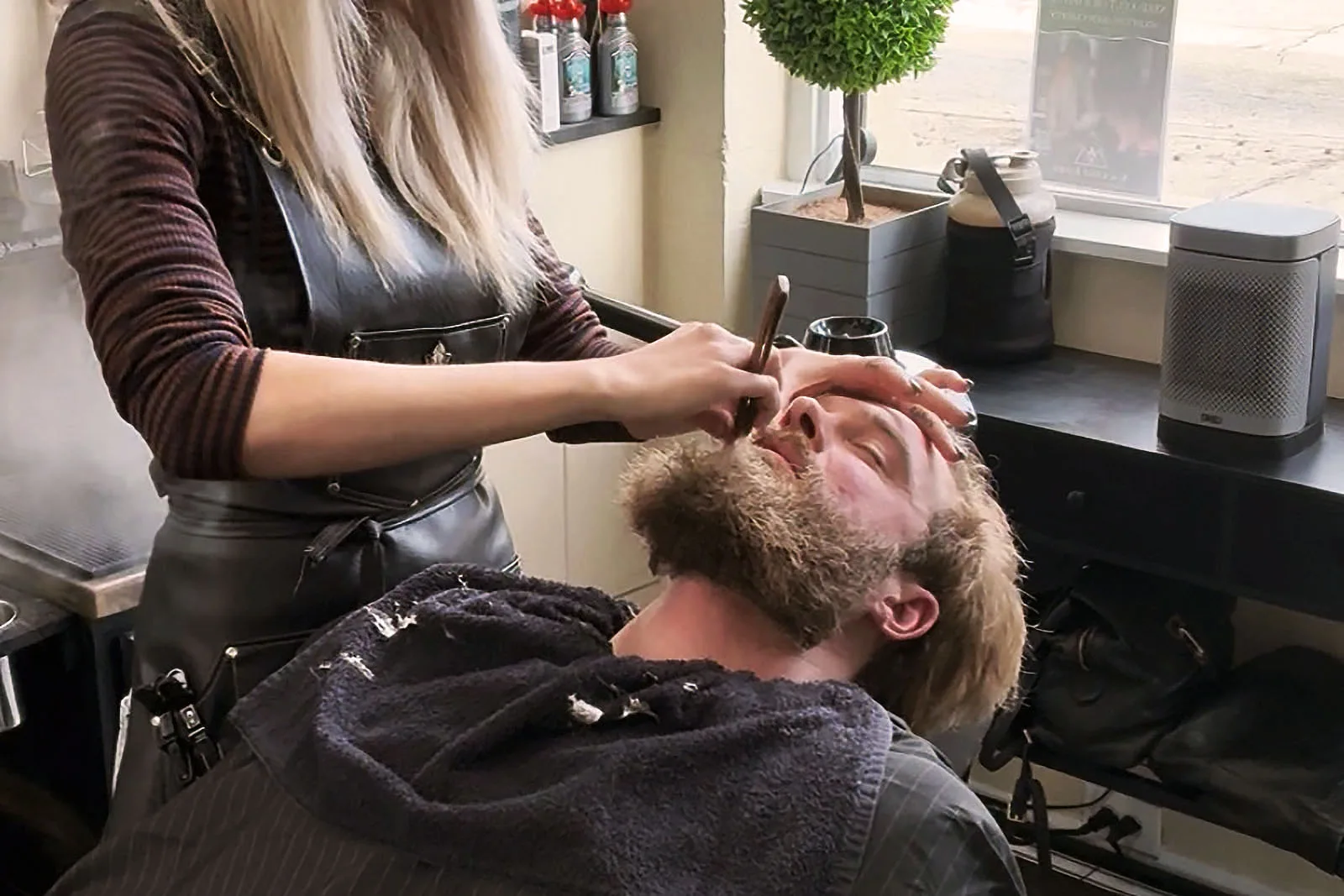 Straight-razor detail finishing a beard trim at Black Hat Barber in downtown Willoughby Ohio