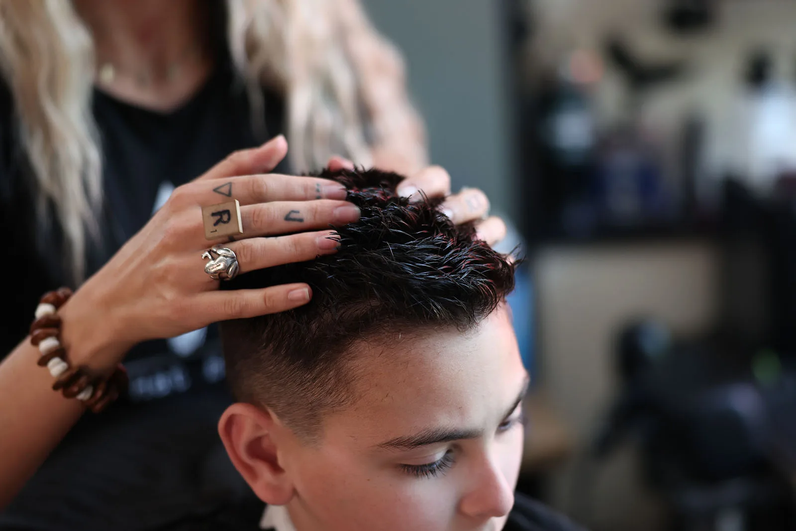 A kid taking a break mid-haircut at Black Hat Barber in downtown Willoughby