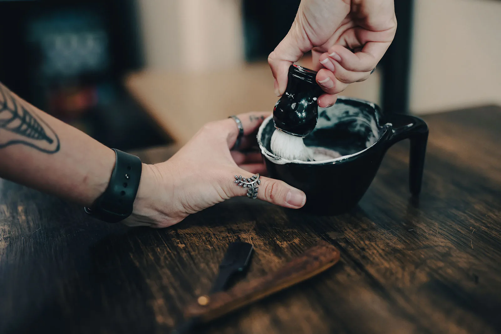 Badger brush whipping lather for a traditional shave at Black Hat Barber